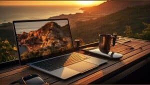 an image of laptop in a table and also a cup of tea with a scenary in background